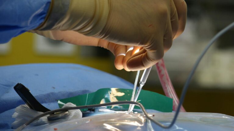 Close-up of a surgeon's hands performing an intricate procedure in the operating room.